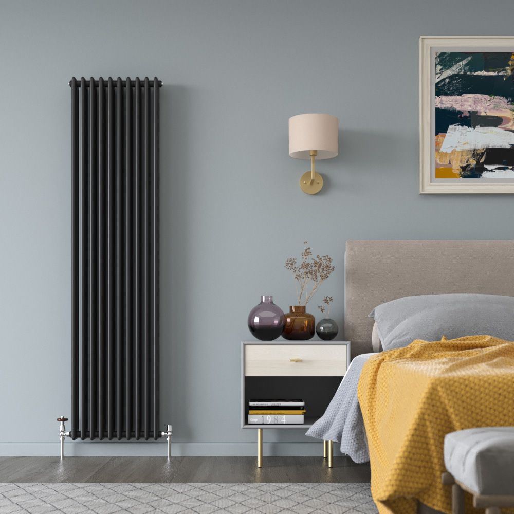 A room with a column radiator installed onto a plasterboard wall